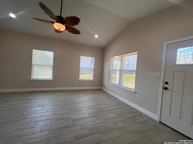 entrance foyer featuring hardwood / wood-style floors, ceiling fan, and vaulted ceiling