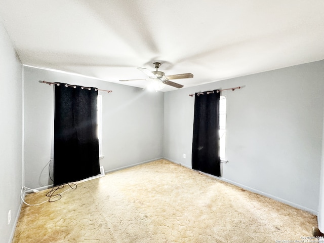 carpeted empty room with ceiling fan