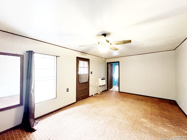 empty room with ceiling fan, carpet floors, and heating unit