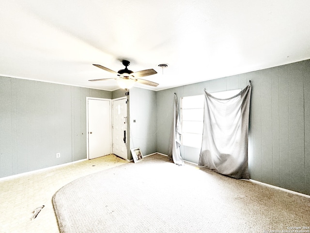 unfurnished bedroom featuring light colored carpet and ceiling fan