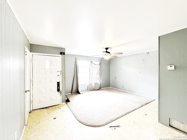 bedroom featuring wood walls and ceiling fan