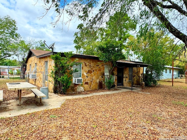 rear view of house featuring cooling unit