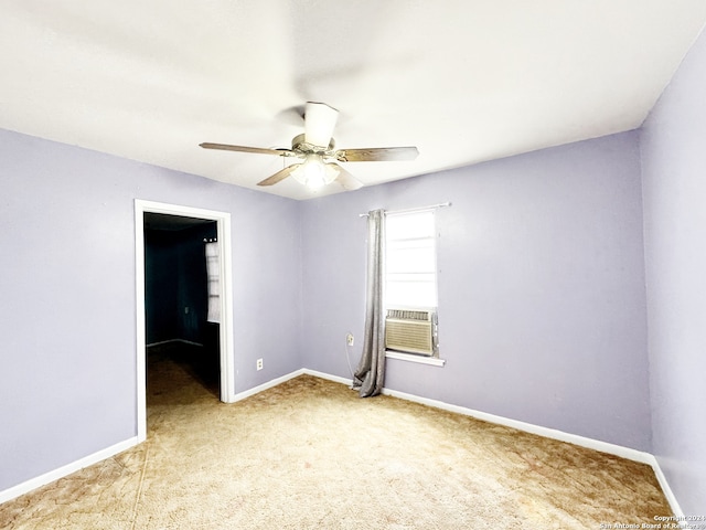 unfurnished room with cooling unit, light colored carpet, and ceiling fan