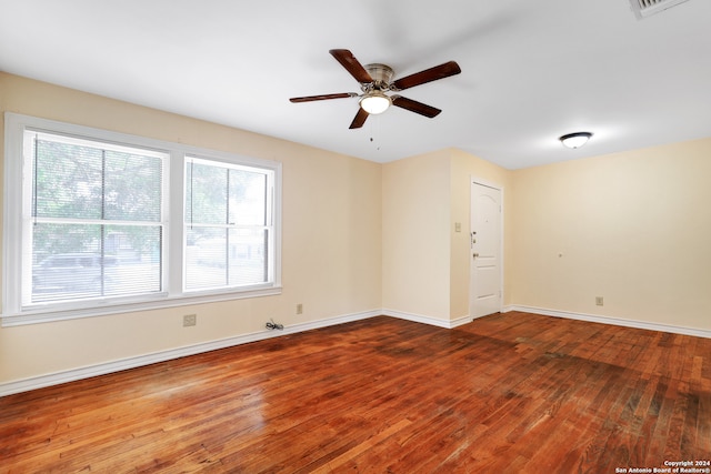 unfurnished room with hardwood / wood-style floors and ceiling fan