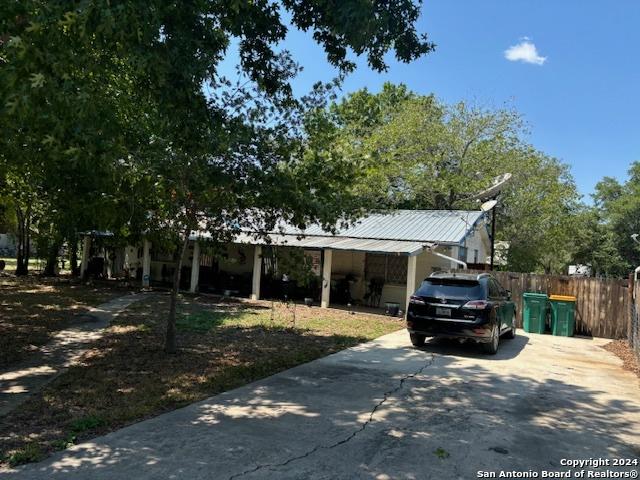 view of front of home with fence and metal roof