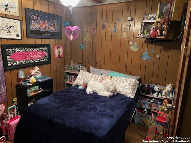 bedroom with wood walls