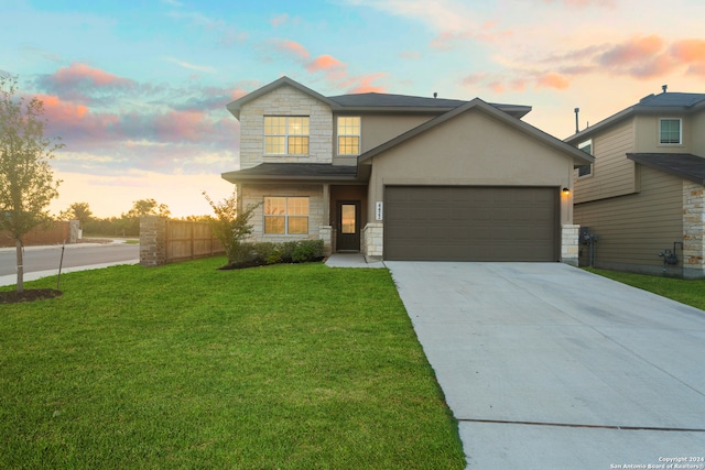 view of front facade with a garage and a yard