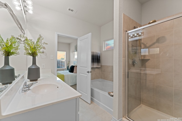 bathroom featuring vanity, tile patterned floors, and shower with separate bathtub