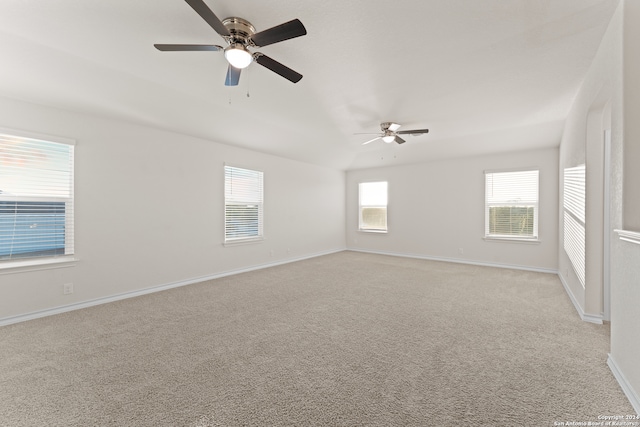 carpeted spare room with ceiling fan