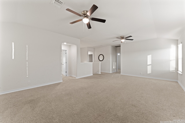 carpeted spare room featuring lofted ceiling and ceiling fan