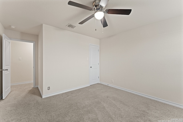 unfurnished bedroom featuring light colored carpet and ceiling fan