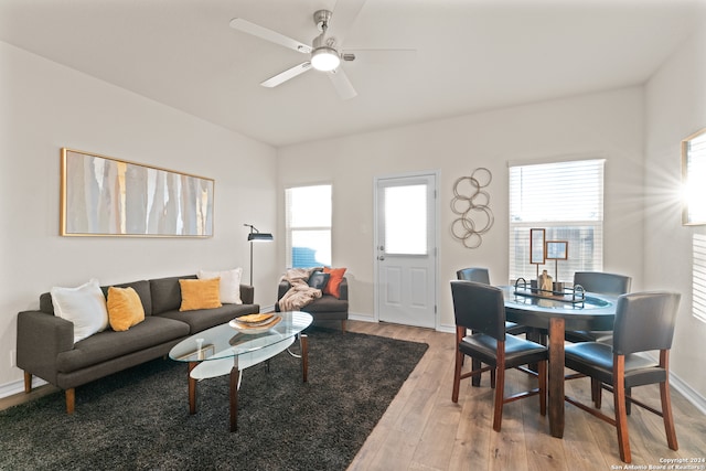 living room with wood-type flooring and ceiling fan