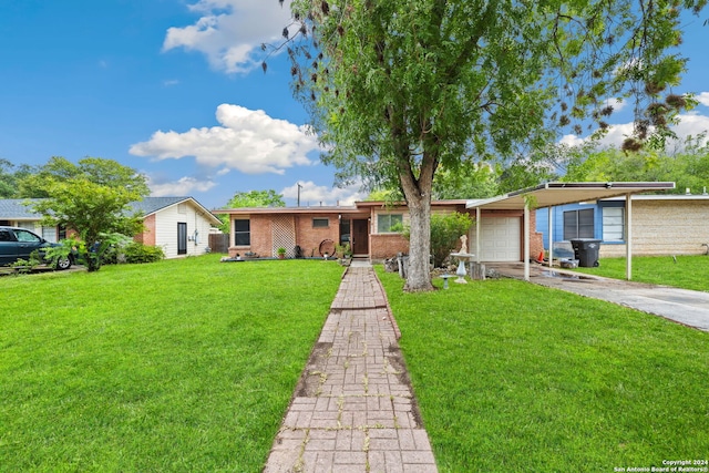 ranch-style house featuring a carport, driveway, brick siding, and a front yard