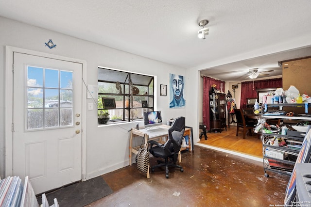 home office with a textured ceiling and ceiling fan