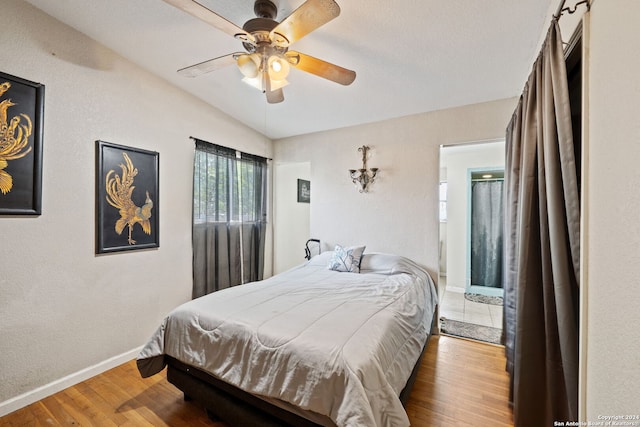 bedroom featuring ceiling fan, lofted ceiling, and wood-type flooring