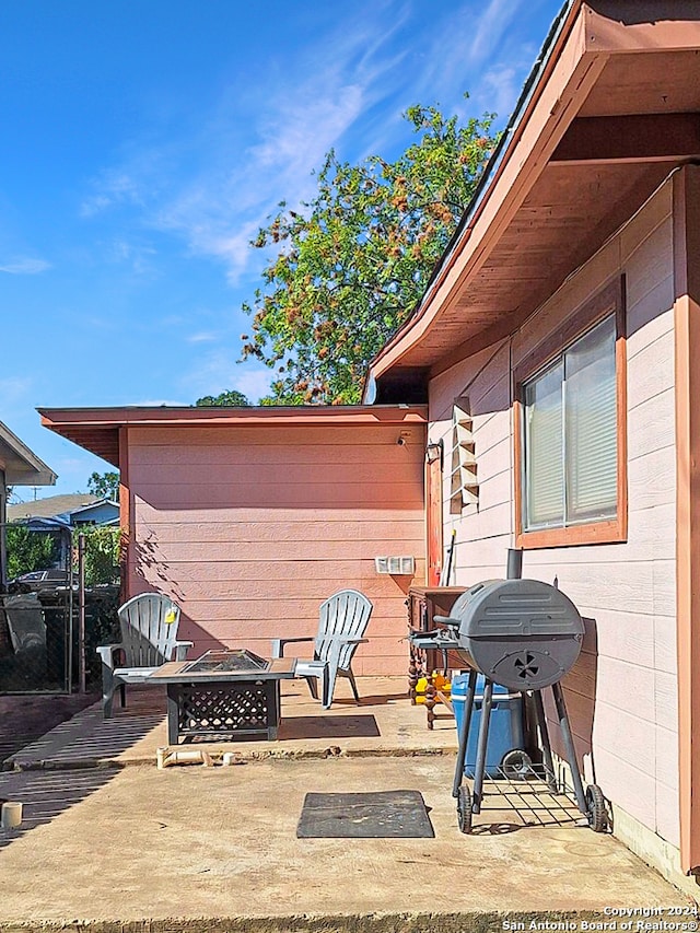 view of patio / terrace with an outdoor fire pit and a grill