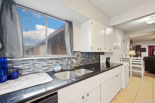 kitchen with tasteful backsplash, sink, white cabinetry, and light tile patterned flooring