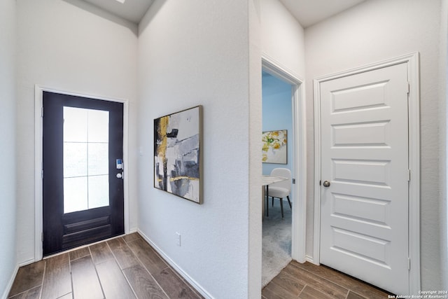 entrance foyer featuring wood finish floors and baseboards