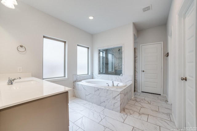 bathroom with vanity, visible vents, walk in shower, a bath, and marble finish floor