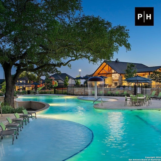 pool featuring a patio area and fence