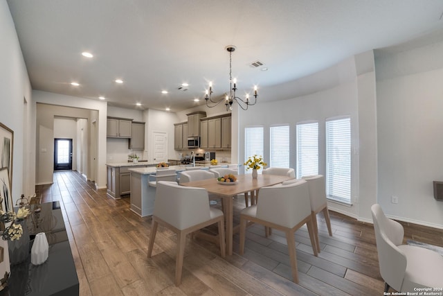 dining space featuring visible vents, baseboards, dark wood finished floors, recessed lighting, and a notable chandelier