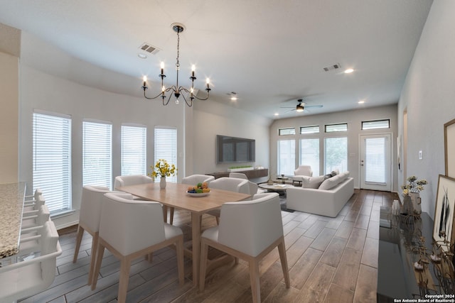 dining space with ceiling fan with notable chandelier, recessed lighting, visible vents, and wood tiled floor