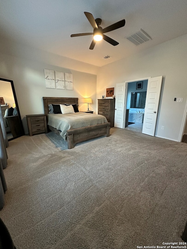 bedroom with ensuite bath, carpet, and ceiling fan