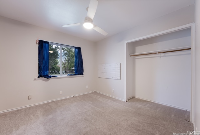 unfurnished bedroom with ceiling fan, a closet, and light carpet