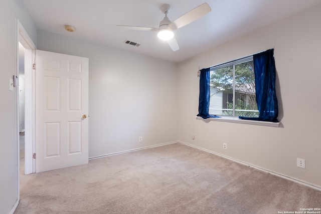 carpeted empty room with ceiling fan