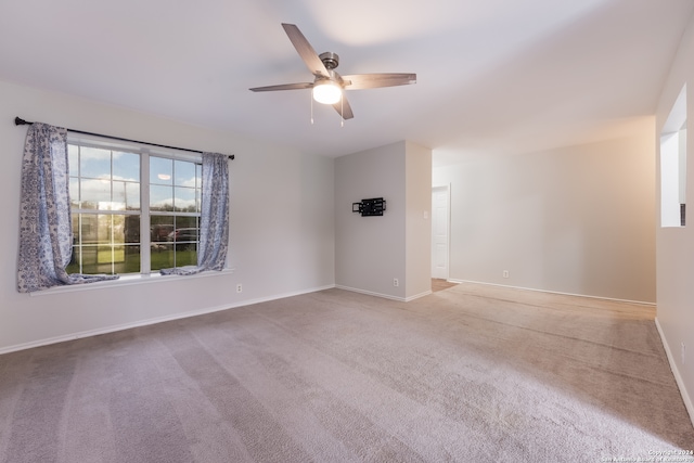 carpeted spare room with ceiling fan