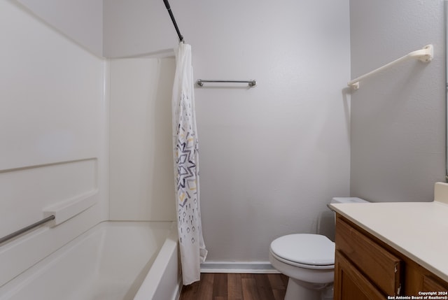 full bathroom with vanity, toilet, wood-type flooring, and shower / bath combo