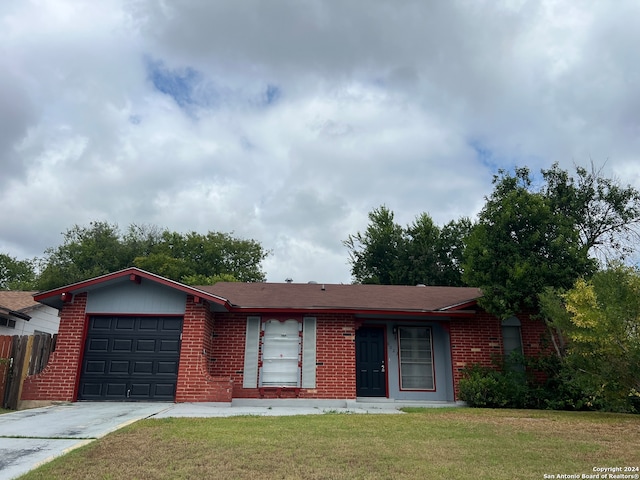 ranch-style home with a garage and a front yard