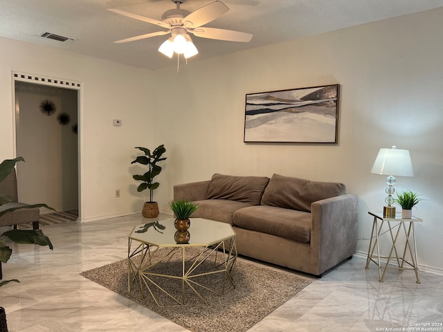 living room featuring a textured ceiling and ceiling fan