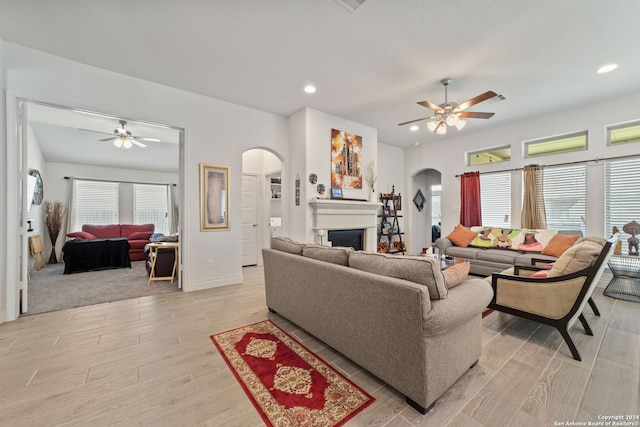 living room featuring light wood-type flooring and ceiling fan