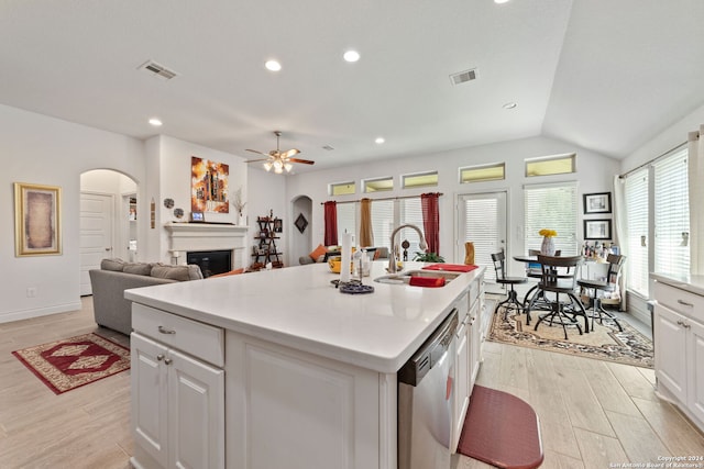 kitchen with white cabinetry, sink, an island with sink, ceiling fan, and stainless steel dishwasher