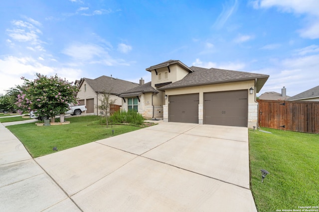 view of front of home with a garage and a front lawn