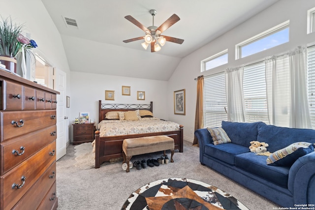 bedroom with vaulted ceiling, light colored carpet, and ceiling fan