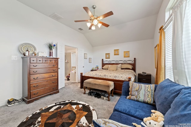 carpeted bedroom featuring ensuite bath, vaulted ceiling, and ceiling fan