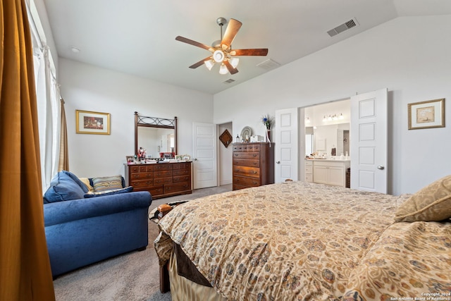 carpeted bedroom featuring vaulted ceiling, multiple windows, ensuite bathroom, and ceiling fan