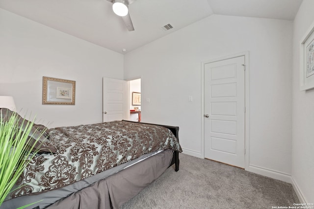 bedroom featuring vaulted ceiling, light colored carpet, and ceiling fan