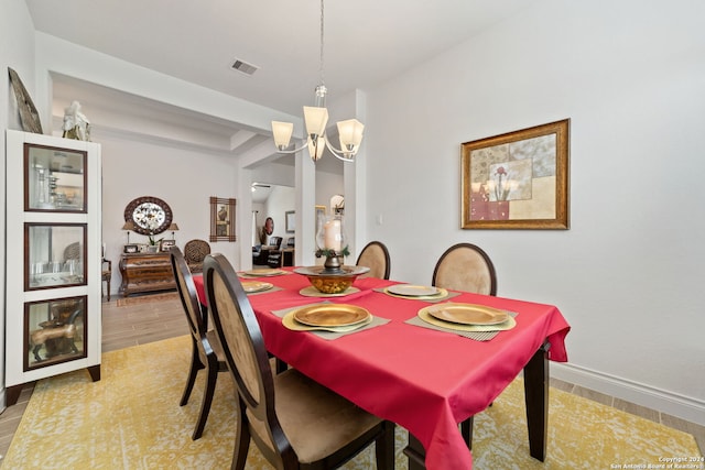 dining area featuring an inviting chandelier and light hardwood / wood-style floors