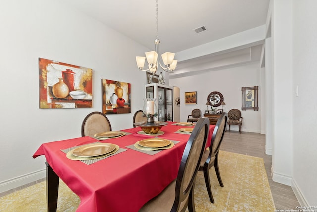 dining space featuring a chandelier and light hardwood / wood-style floors