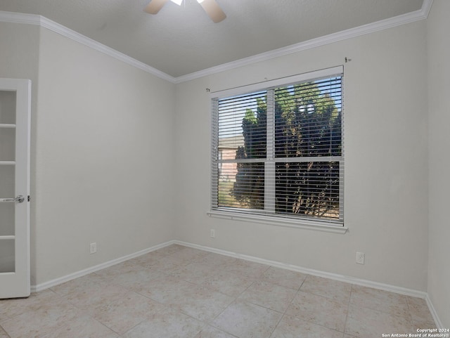 tiled empty room with ceiling fan, crown molding, and a textured ceiling