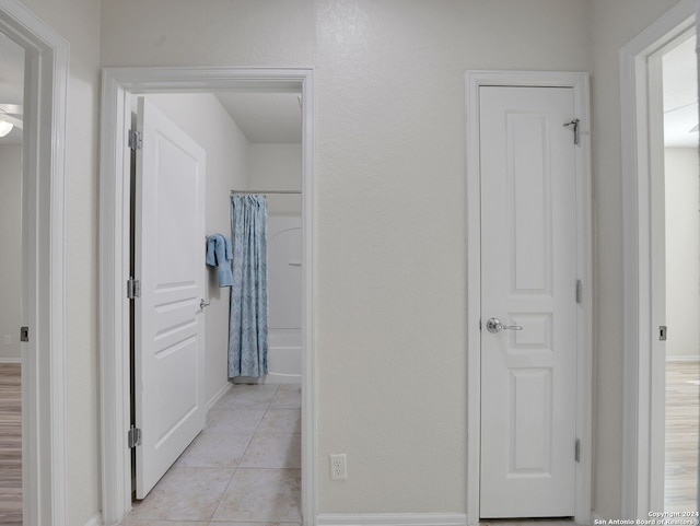 corridor featuring light tile patterned floors