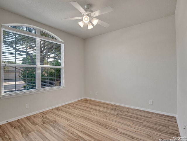 spare room featuring ceiling fan and light hardwood / wood-style flooring