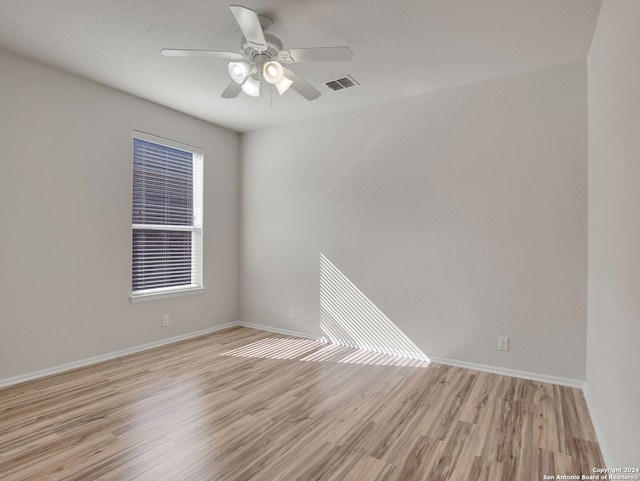 empty room featuring ceiling fan and light wood-type flooring