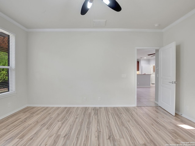 spare room featuring ceiling fan, crown molding, and light hardwood / wood-style flooring