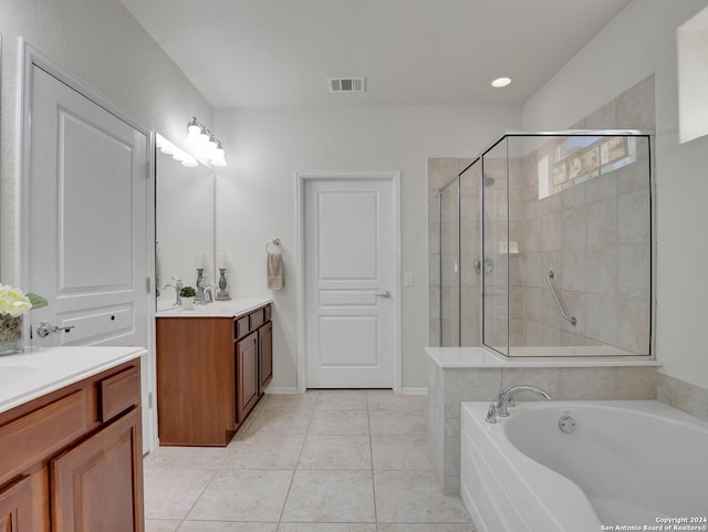 bathroom with tile patterned flooring, vanity, and shower with separate bathtub