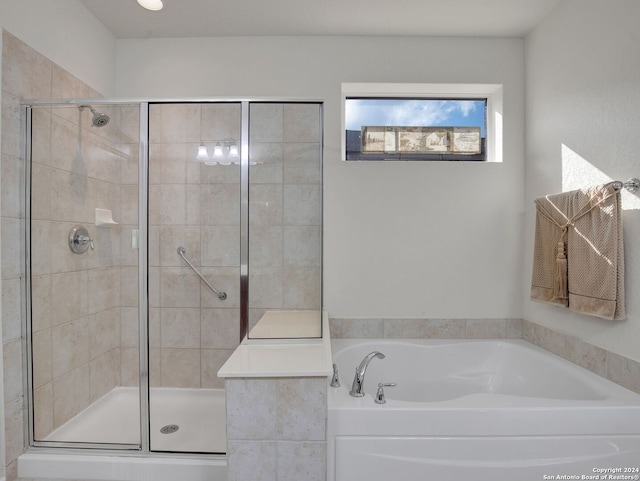 bathroom featuring independent shower and bath