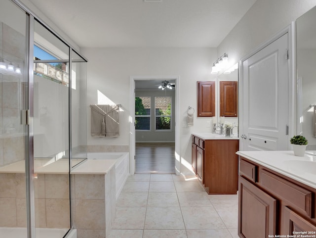 bathroom featuring plus walk in shower, ceiling fan, tile patterned flooring, and vanity